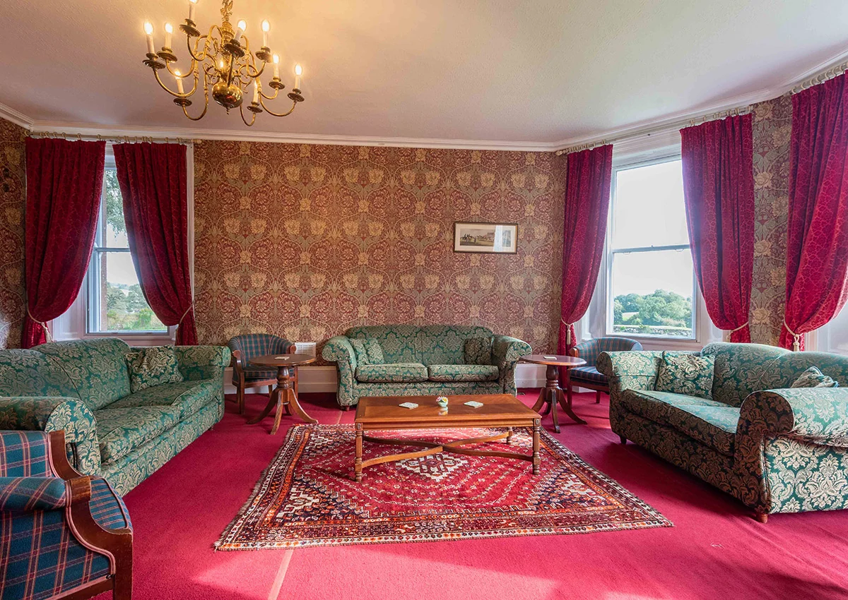The lounge at Cholwell Hall showing 3 sofas, 3 chairs and a coffee table