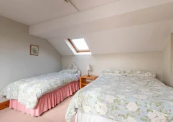 A double bed and a single bed in the Peony suite second bedroom