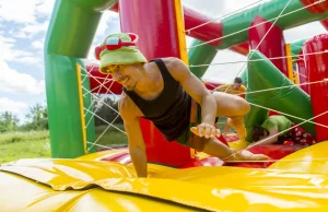 Man playing on a colourful bouncy castle